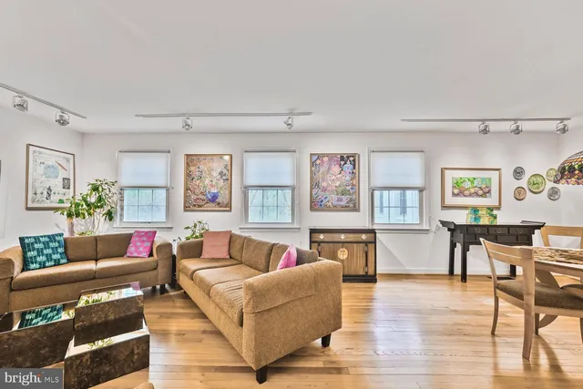 a bedroom with a bed chair and a large window