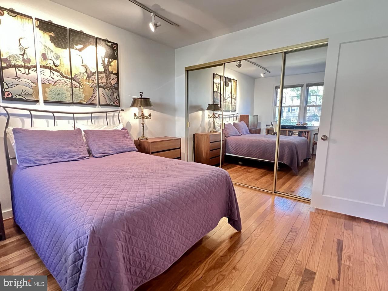 2212 Washington Avenue, Unit 102 Silver Spring, MD 20910 - Photo 13 of 27 a bedroom with a large bed and wooden floor