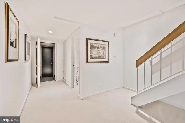 a living room with furniture and stairs