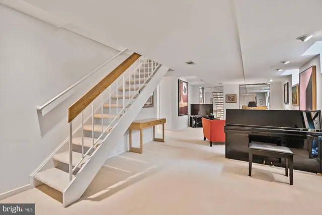 a living room with furniture a flat screen tv and kitchen view