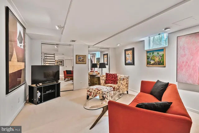 a blue couch sitting in a living room next to a lamp