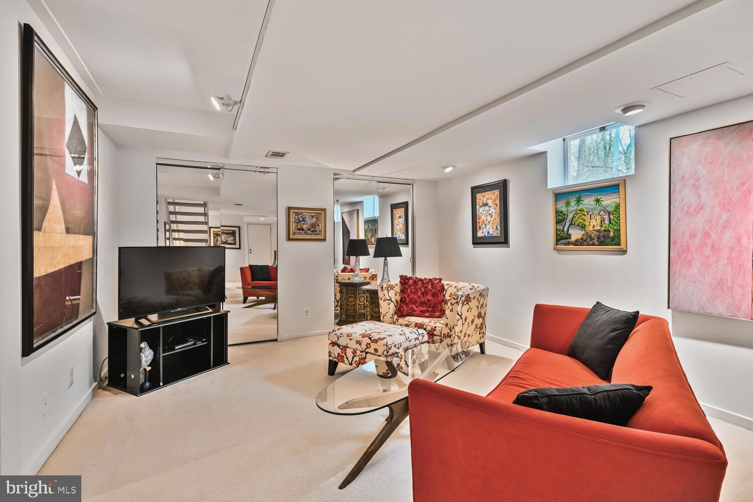 2212 Washington Avenue, Unit 102 Silver Spring, MD 20910 - Photo 17 of 27 a living room with furniture a flat screen tv and kitchen view