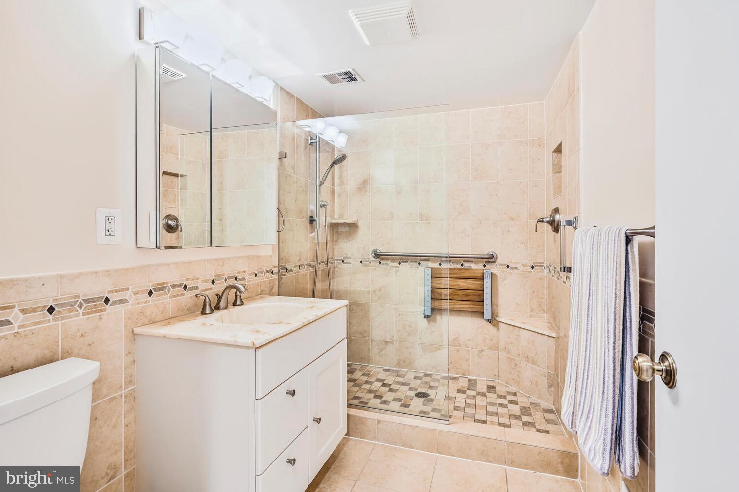 2212 Washington Avenue, Unit 102 Silver Spring, MD 20910 - Photo 21 of 27 a bathroom with a sink toilet and shower
