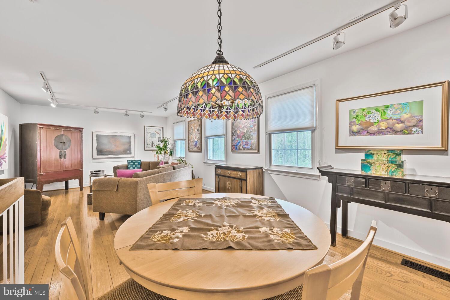 2212 Washington Avenue, Unit 102 Silver Spring, MD 20910 - Photo 7 of 27 a view of a dining room with furniture a chandelier and wooden floor