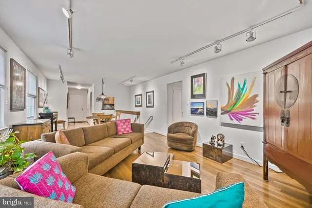 a living room with furniture and wooden floor