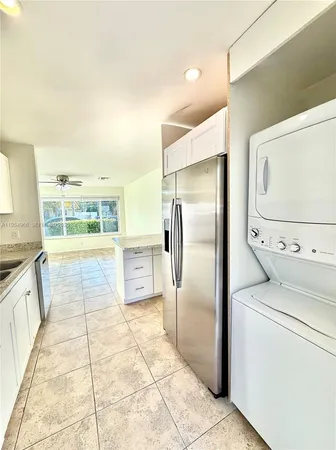 a kitchen with stainless steel appliances a stove a sink and a refrigerator