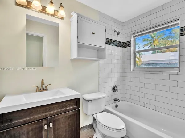 a bathroom with a sink toilet and mirror