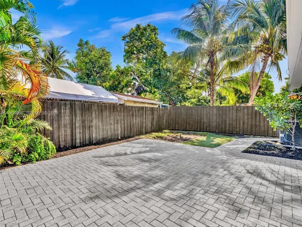 a view of garden with wooden fence