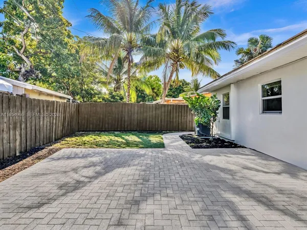a view of a backyard with plants and a patio