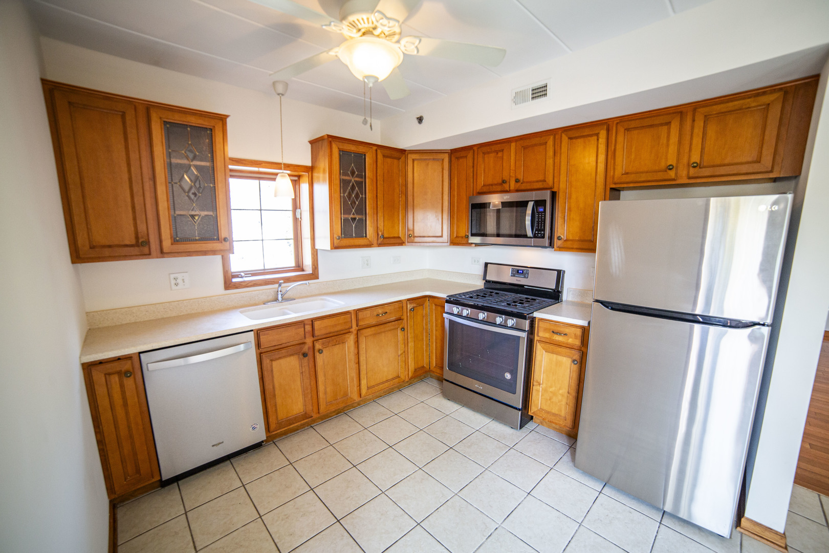 5368 West 96th Street, Unit 2S Oak Lawn, IL 60453 - Photo 3 of 18 a kitchen with granite countertop stainless steel appliances a refrigerator stove top oven and sink