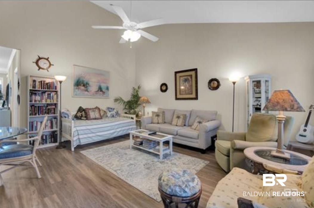 430 West Fort Morgan Road Gulf Shores, AL 36542 - Photo 10 of 27 Spacious living area featuring vaulted ceilings, wood-finish flooring, and a ceiling fan