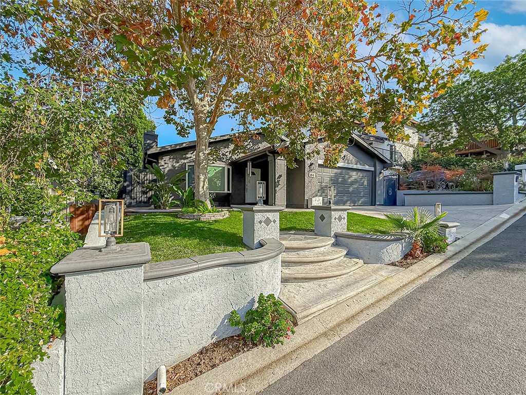184 Pepper Road Newbury Park, CA 91320 - Photo 3 of 43 a front view of a house with a yard table and chairs