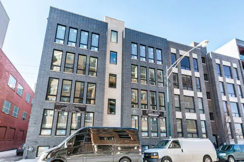 a car parked in front of a brick building