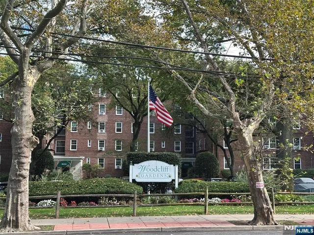 a view of a street with a building and a street sign