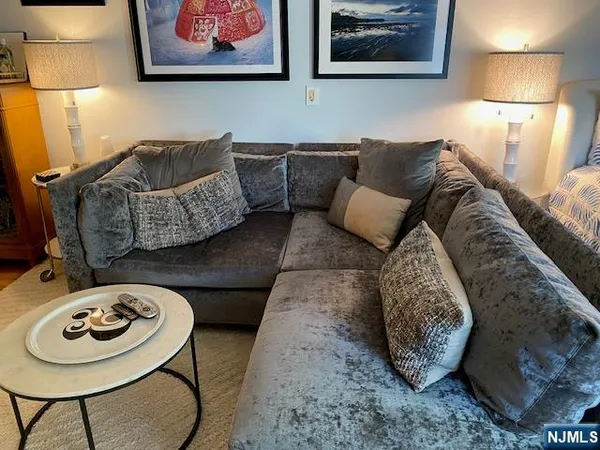 a living room with furniture and a lamp