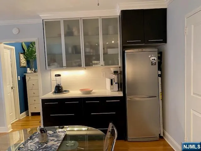 a living room with a bed furniture and a flat screen tv