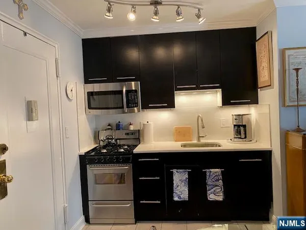 a kitchen with stainless steel appliances a sink stove and refrigerator