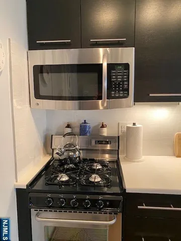 a stove top oven sitting inside of a kitchen