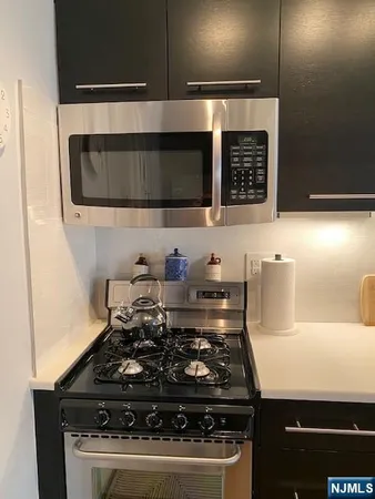 a stove top oven sitting inside of a kitchen