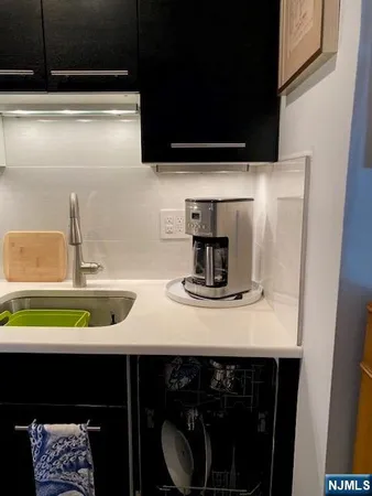 a kitchen with a sink a stove and cabinets