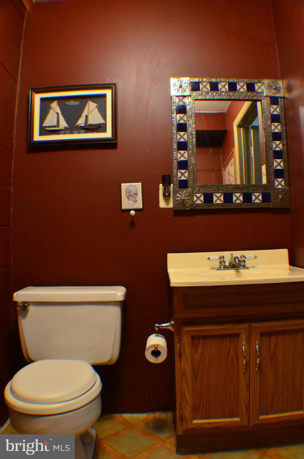 1700 Abelia Road Fallston, MD 21047 - Photo 14 of 30 a bathroom with a toilet a sink and mirror