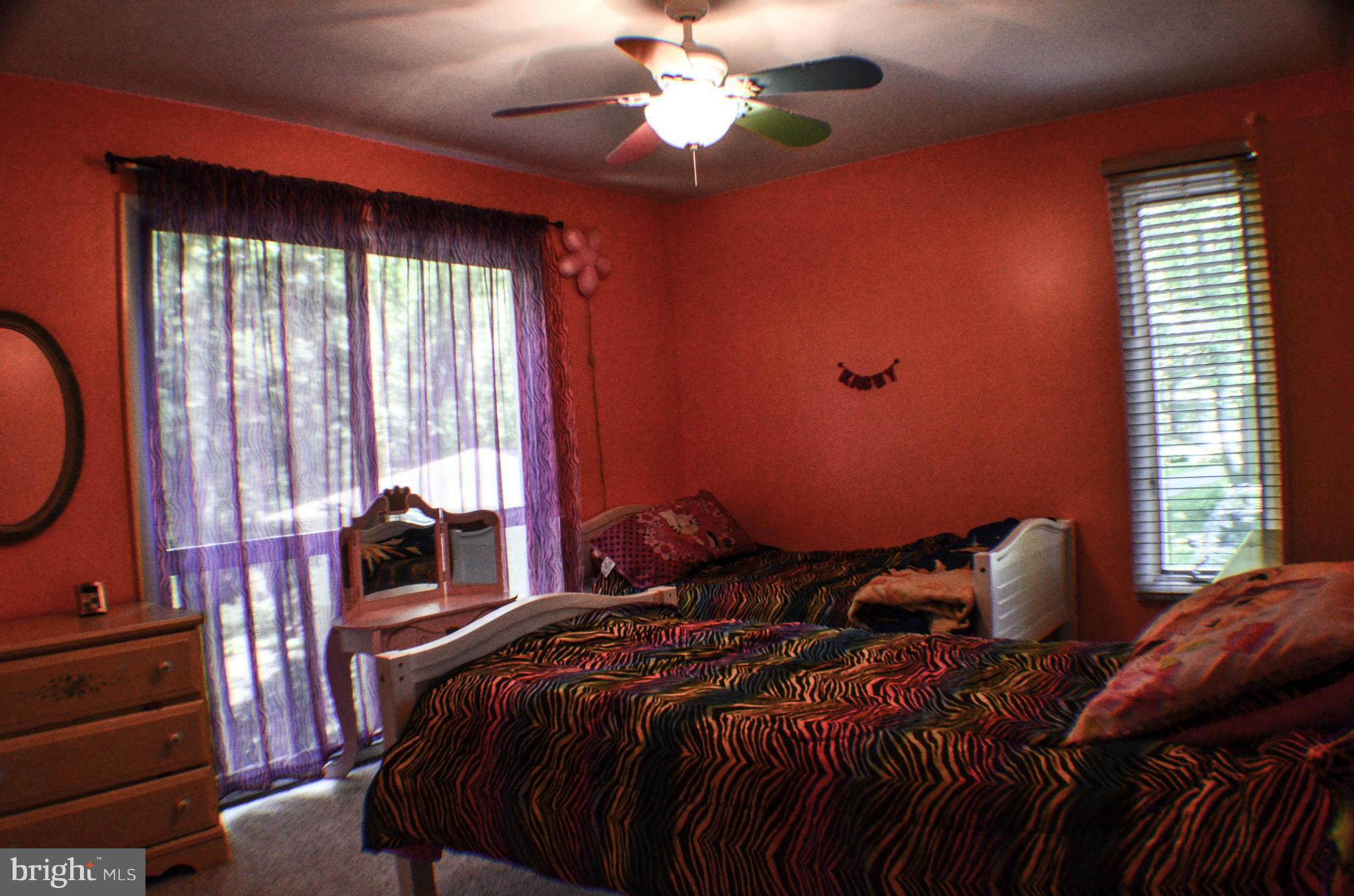 1700 Abelia Road Fallston, MD 21047 - Photo 17 of 30 a bedroom with a bed and a chandelier