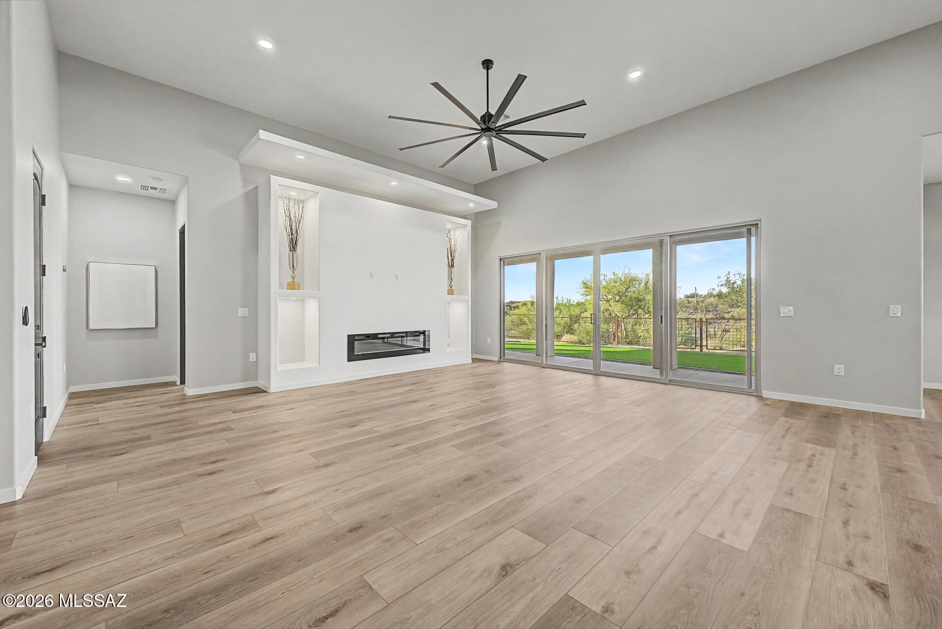 2399 Della Roccia Court Tucson, AZ 85737 - Photo 6 of 34 a view of an empty room with wooden floor and a window