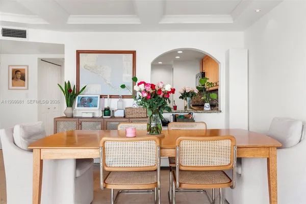 a dining room with furniture and wooden floor