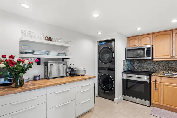 a kitchen with cabinets and a stove top oven