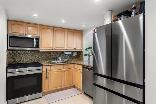 a kitchen with a refrigerator sink and microwave