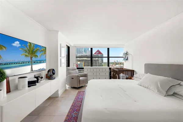 a living room with furniture large window and flat screen tv