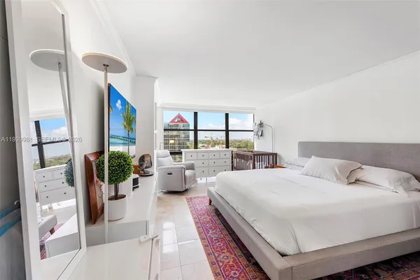 a room with a bed and glass door