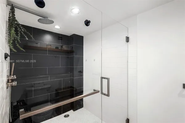 a en suite bathroom with a sink a mirror and a shower
