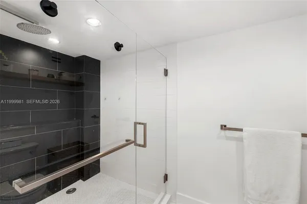 a en suite bathroom with a sink a mirror and a shower