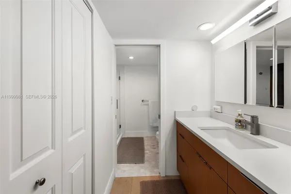 a bathroom with a sink a toilet and a mirror