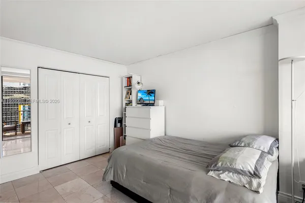 a very nice looking room with a large window and potted plants