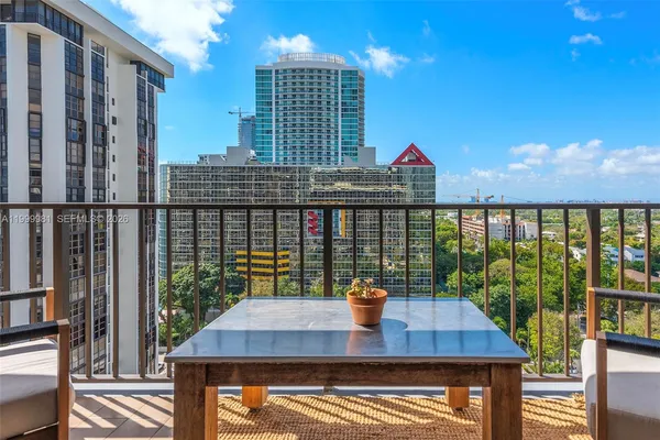 a hallway with painting and a table