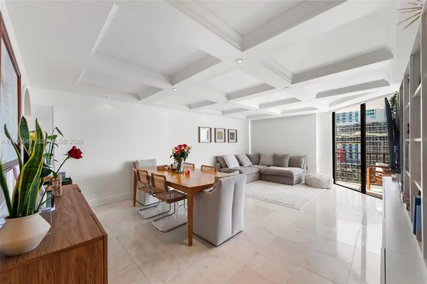 a living room with furniture and flowers