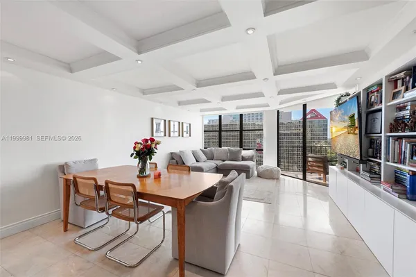 a dining room with furniture and a potted plant