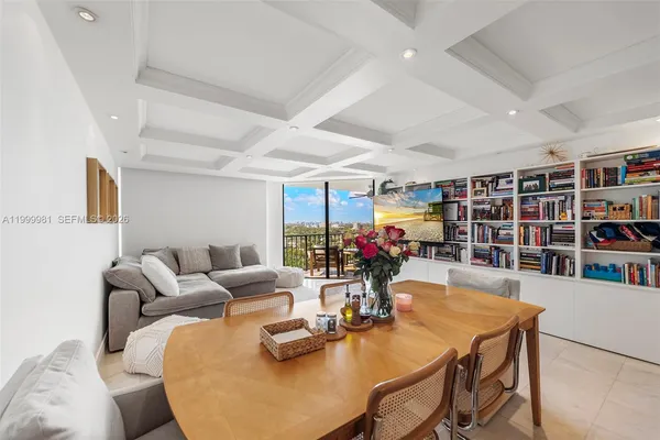 a living room with furniture and a book shelf