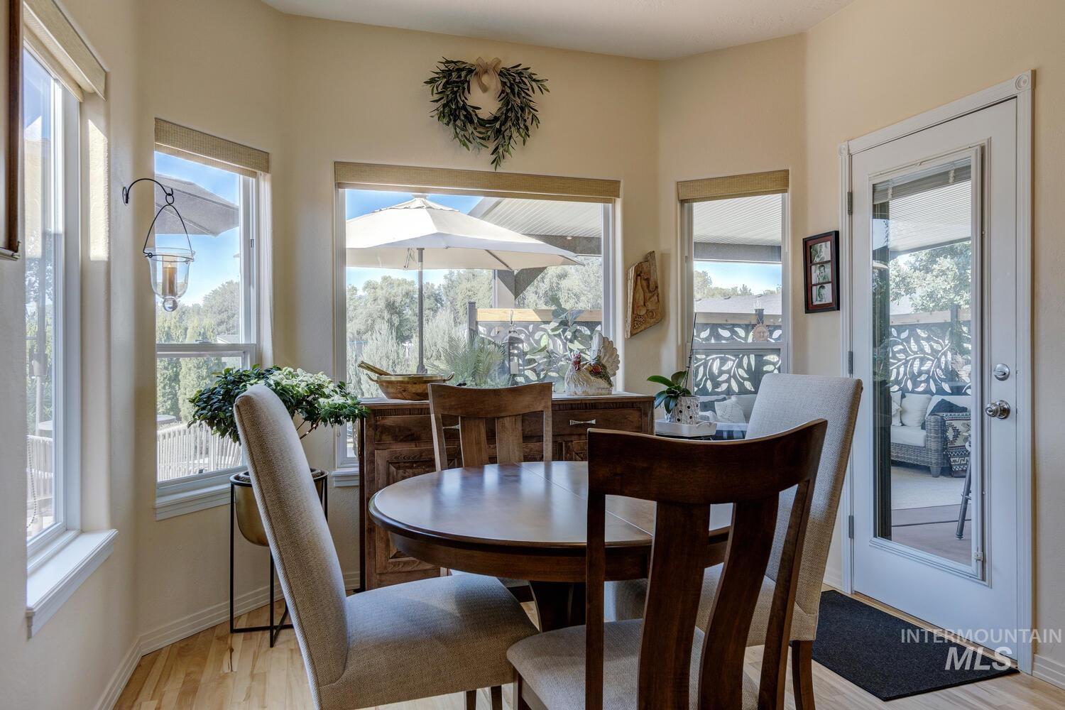 10585 West Vega Court Star, ID 83669 - Photo 14 of 49 Dining room featuring plenty of natural light and light wood-style floors