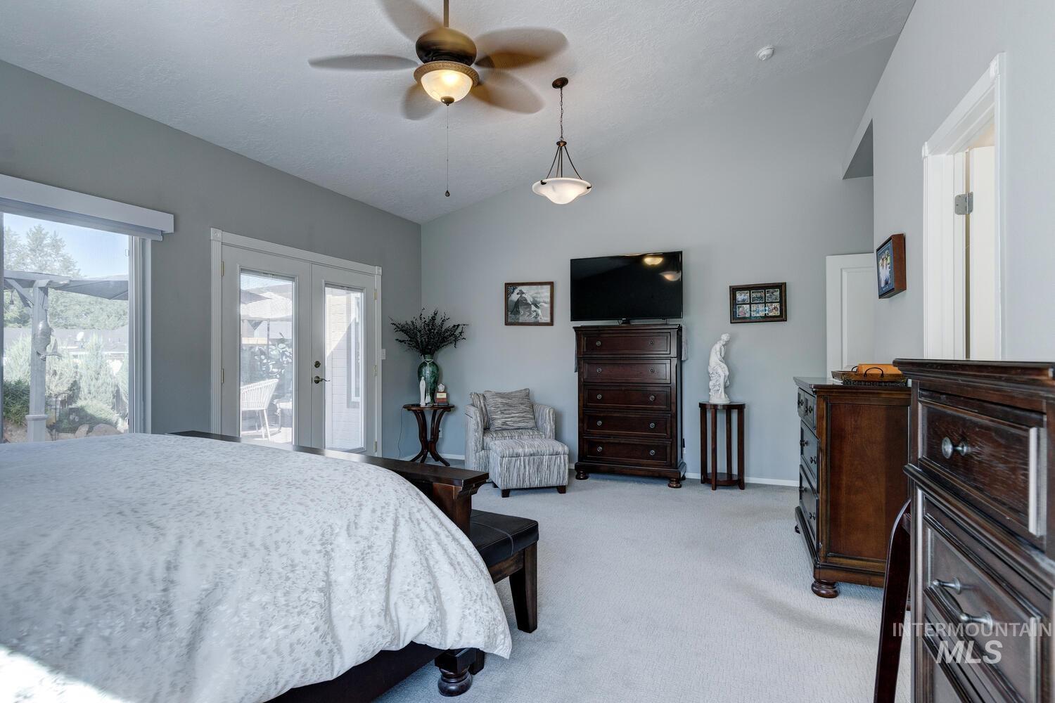 10585 West Vega Court Star, ID 83669 - Photo 18 of 49 Bedroom with light carpet, vaulted ceiling, a ceiling fan, french doors, and access to outside