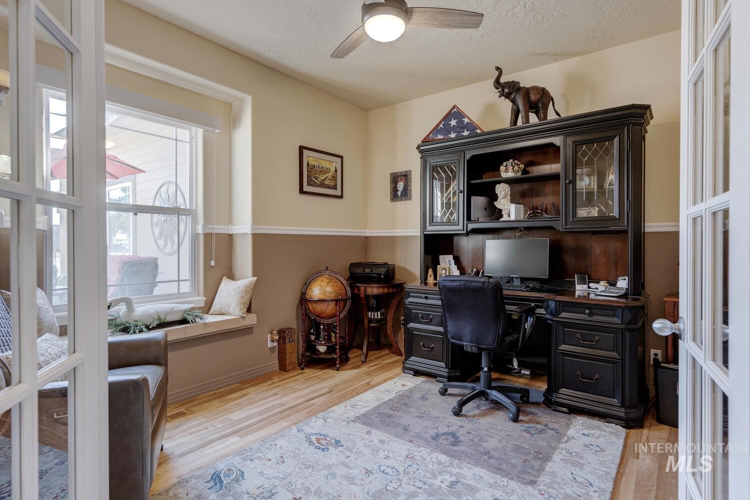 10585 West Vega Court Star, ID 83669 - Photo 22 of 49 Office featuring a ceiling fan, light wood-style floors, and a textured ceiling