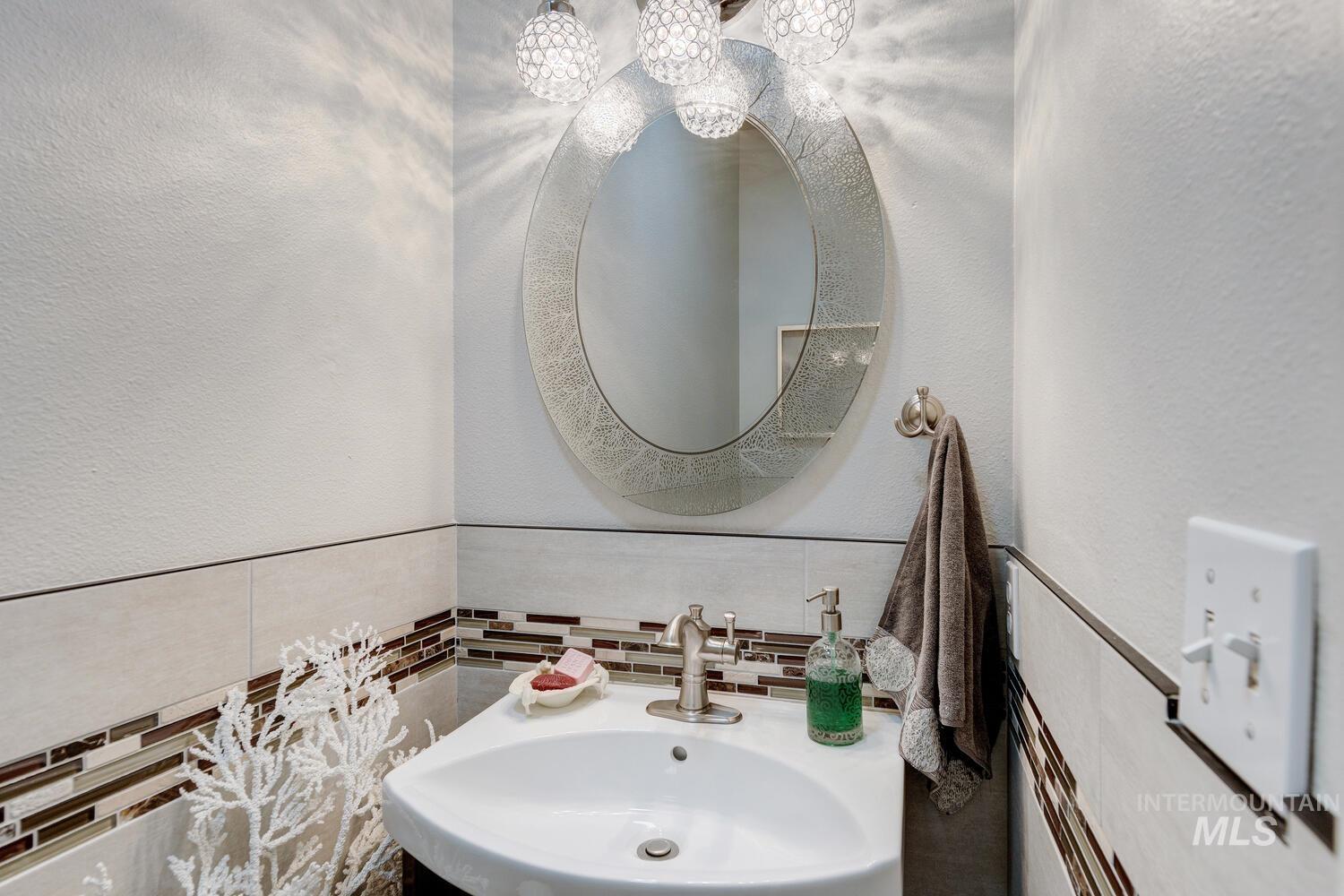 10585 West Vega Court Star, ID 83669 - Photo 26 of 49 Bathroom with a textured wall and tile walls