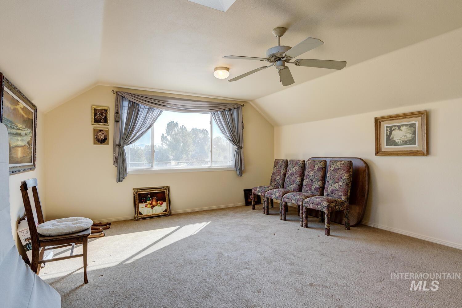 10585 West Vega Court Star, ID 83669 - Photo 27 of 49 Living area with a skylight, vaulted ceiling, and carpet flooring