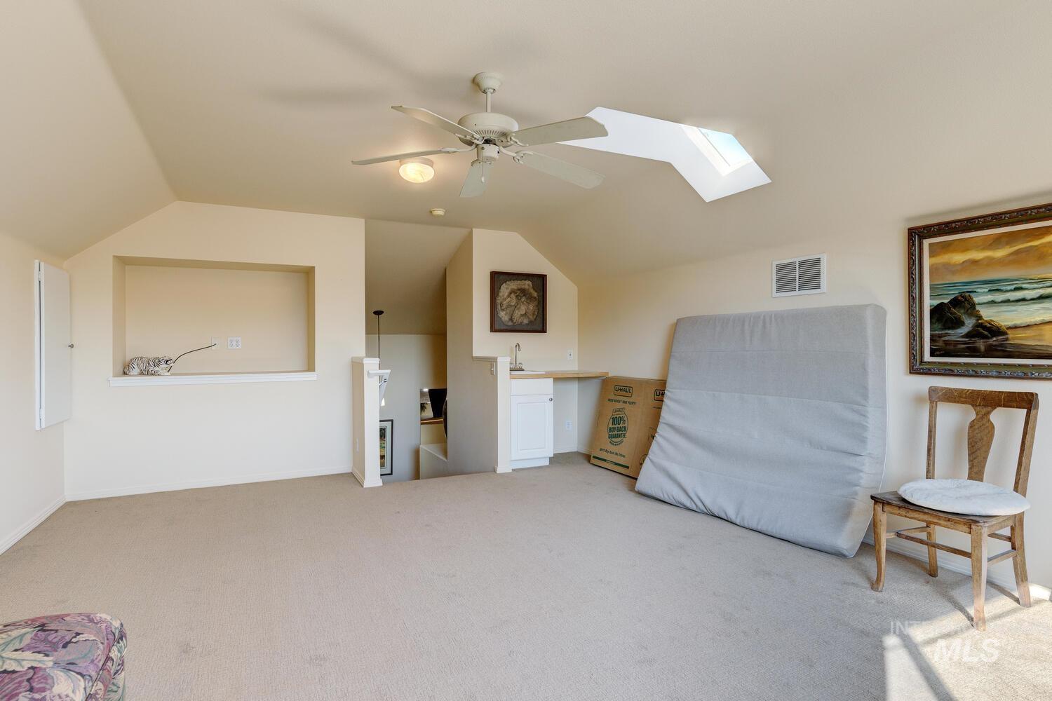 10585 West Vega Court Star, ID 83669 - Photo 28 of 49 Sitting room with a skylight, an upstairs landing, light carpet, vaulted ceiling, and ceiling fan