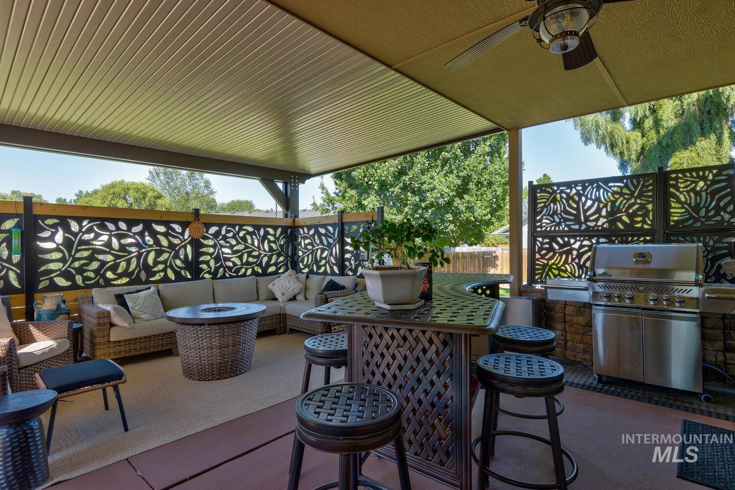 10585 West Vega Court Star, ID 83669 - Photo 31 of 49 View of patio / terrace with an outdoor living space with a fire pit, ceiling fan, and grilling area