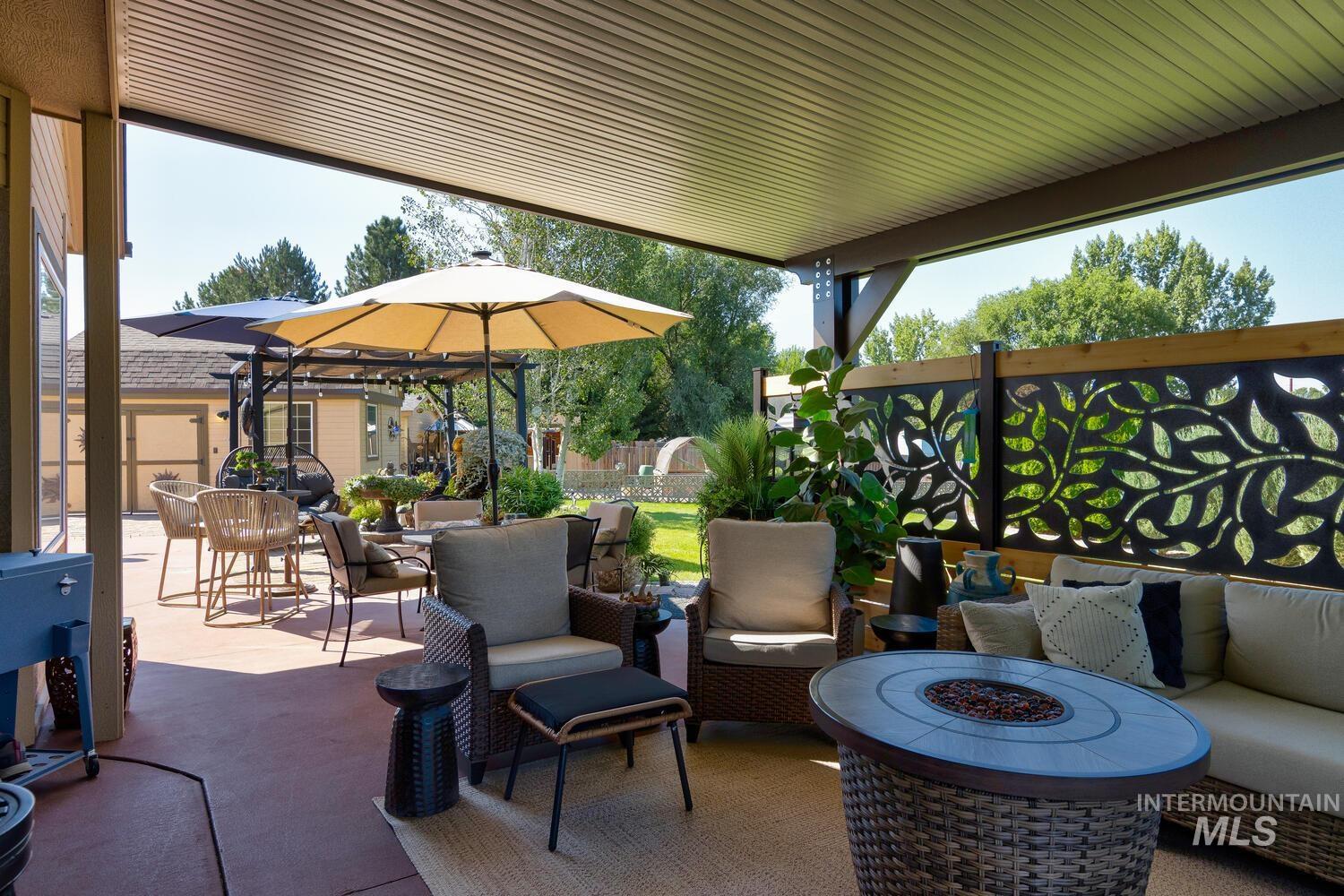 10585 West Vega Court Star, ID 83669 - Photo 33 of 49 View of patio / terrace with an outdoor living space with a fire pit and outdoor dining space