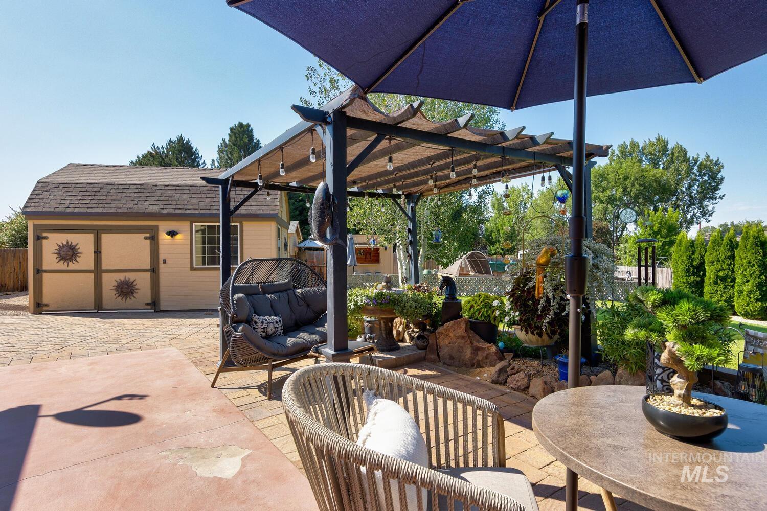 10585 West Vega Court Star, ID 83669 - Photo 35 of 49 View of patio / terrace featuring an outdoor hangout area, a pergola, and an outbuilding
