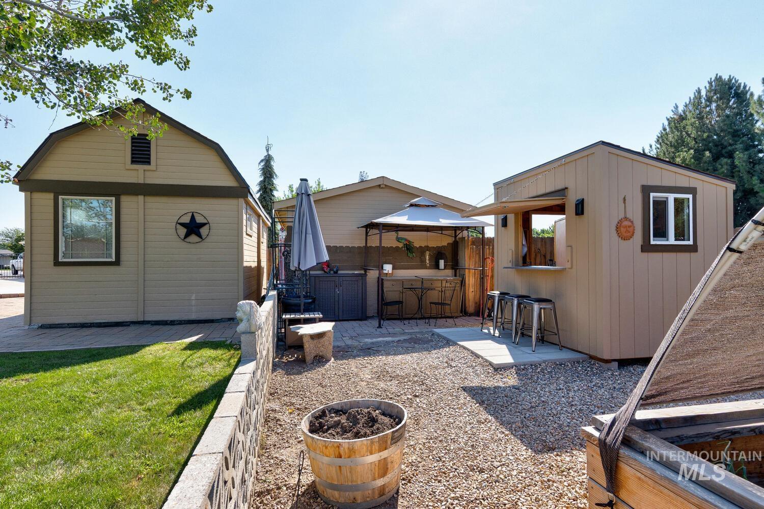 10585 West Vega Court Star, ID 83669 - Photo 39 of 49 View of grassy yard with a gazebo, a patio area, and an outdoor structure
